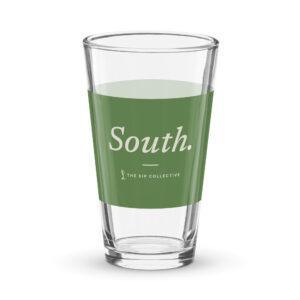 Clear pint glass with a green band printed "South"