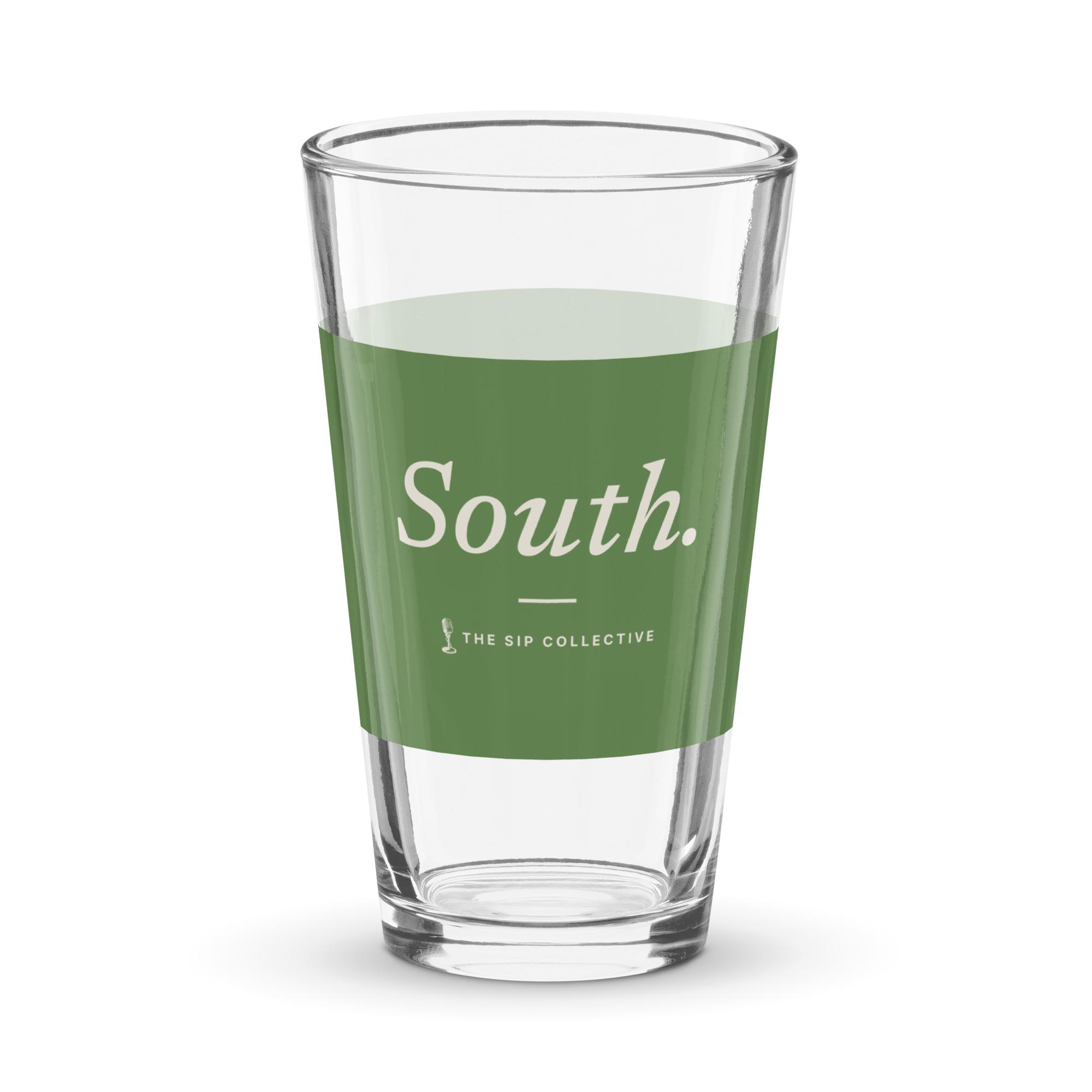Clear pint glass with a green band printed "South"