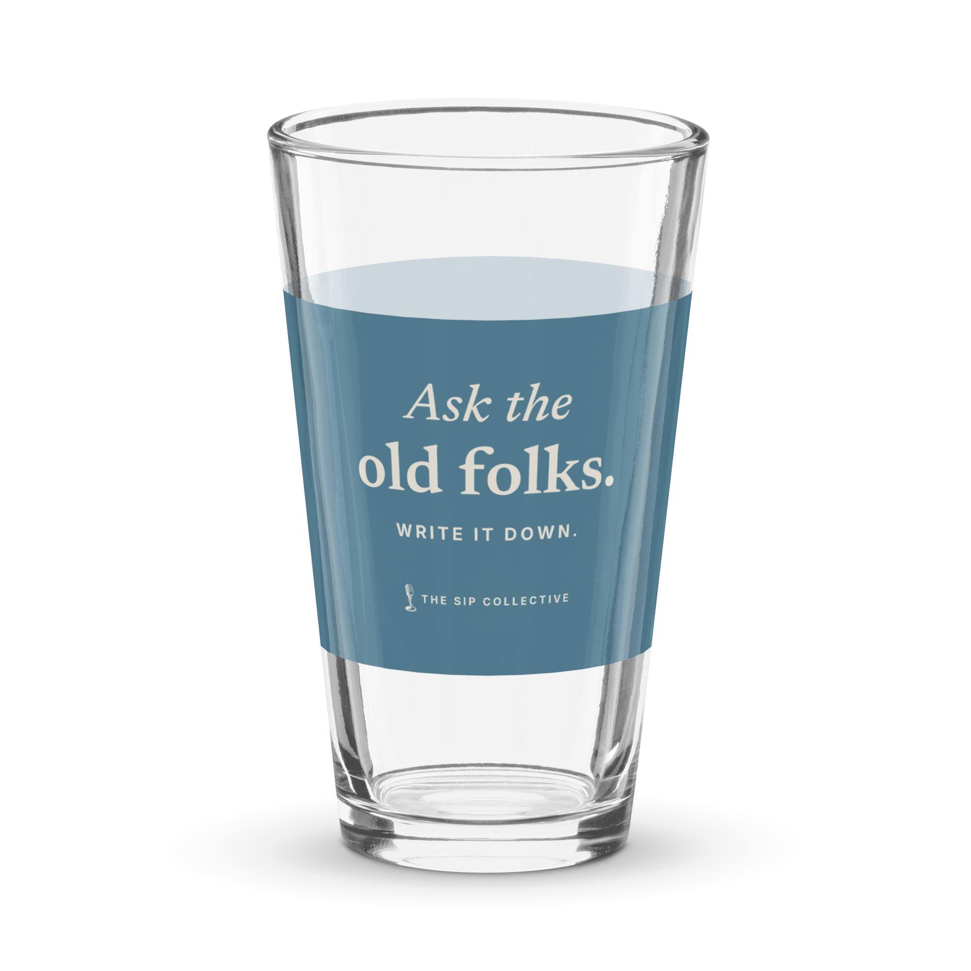 Clear pint glass with a blue band printed "Ask the old folks"