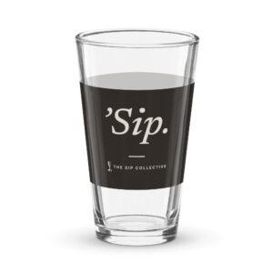 Clear pint glass with a black band printed "'Sip"
