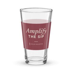 Clear pint glass with a wine-colored band printed "Amplify The Sip"